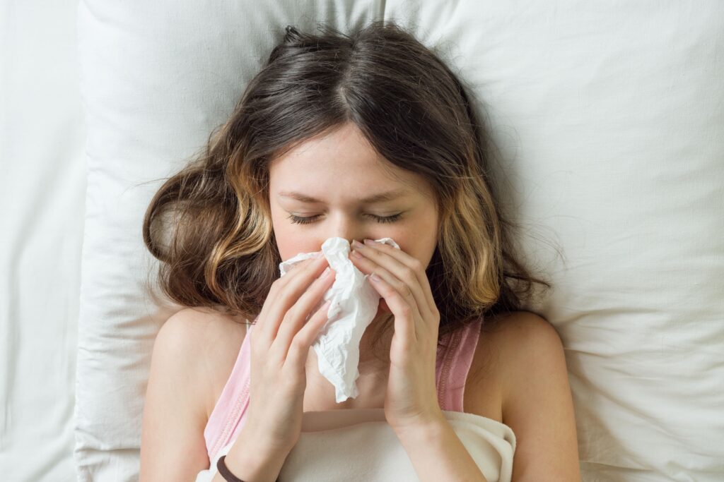 cold flu season runny nose sick girl on bed snee 2021 12 21 02 26 48 utc